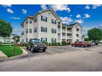 Three story condo building with parking and blue shutters with well-maintained landscaping at 901 West Port Dr. # 305, North Myrtle Beach, SC 29582