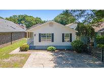 Charming home featuring a concrete driveway, small porch and black shutters in a neighborhood full of trees at 10071 Kings Rd., Myrtle Beach, SC 29572
