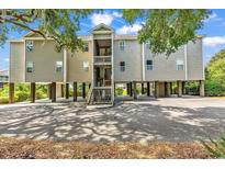 Desirable elevated beach home in Myrtle Beach with stairway entry and ground floor parking at 140 South Cove Pl. # 6C, Pawleys Island, SC 29585