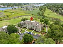 Beautiful aerial view of a low-rise condo building surrounded by lush golf course and the Intracoastal waterway at 1401 Lighthouse Dr. # 4334, Little River, SC 29566