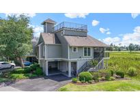 Beautiful two-story home with a rooftop deck, ground floor parking, and landscaped front yard at 1663 Harbor Dr., North Myrtle Beach, SC 29582