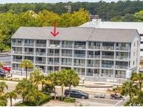Multi-story condo building with balconies, palm trees, and an ocean view in a tourist area at 2000 S Ocean Blvd. # V405, Myrtle Beach, SC 29577