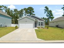 Charming one-story home with attached garage, well-manicured lawn, and lovely landscaping at 228 Averyville Dr., Conway, SC 29526