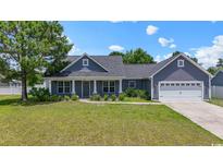 Charming single-story home with gray siding, a manicured lawn, and an attached two-car garage at 250 Penn Circle, Galivants Ferry, SC 29544