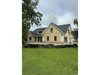 Charming new build featuring vertical siding, a dark roof, and brick accents, set against a lush green lawn at 287 All Saints Loop, Pawleys Island, SC 29585