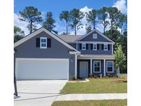 Charming two-story home featuring a two-car garage, symmetrical windows and black shutters and freshly sodded lawn at 331 Rivers Edge Dr., Myrtle Beach, SC 29588