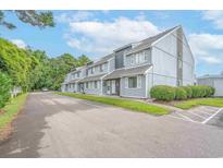 Charming multi-Gathering building featuring a well-maintained yard and ample parking spaces at 3700 Golf Colony Lane # 26A, Little River, SC 29566