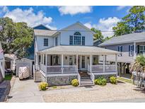Charming two-story home with a wide porch, stone accents, and mature landscaping offers curb appeal at 6001- P16A S Kings Highway, Myrtle Beach, SC 29575