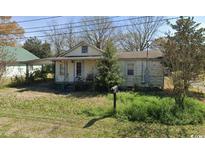 Quaint one-story home with a small front porch and yard, offering a cozy and traditional aesthetic appeal at 605 Canal St., Georgetown, SC 29440