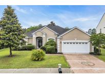 Charming one-story home featuring a two-car garage, manicured landscaping, and a welcoming front entrance at 760 Carolina Farms Blvd., Myrtle Beach, SC 29579