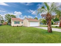 Charming home with a well-maintained lawn, a long driveway, and a detached garage at 100 St. Andrews Ln., Myrtle Beach, SC 29588