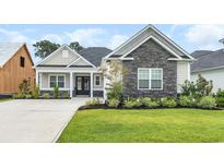 Charming single-story home featuring stone accents, manicured lawn, and a welcoming front porch at 1024 Pochard Dr., Conway, SC 29526
