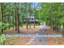 A charming exterior view of this beautiful home nestled among trees on a spacious lot at 1072 Chelsey Circle, Conway, SC 29526