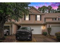Charming two-story townhome with black shutters, a white garage door, and driveway with a black truck parked at 1120 Fairway Ln. # 1120, Conway, SC 29526