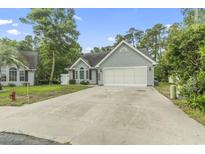 Charming home with a two-car garage and a well-maintained lawn at 1331 Bermuda Ct., Surfside Beach, SC 29575