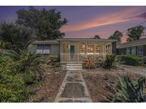 Charming home featuring a landscaped front yard with a tiled pathway leading to a screened-in porch at 1416 Edge Dr., North Myrtle Beach, SC 29582