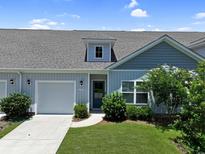 Charming single-story home featuring a well-manicured lawn, attached garage, and inviting front entrance at 184 Sea Shell Dr. # 12, Murrells Inlet, SC 29576