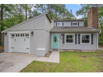 Charming home with a well-maintained front yard, attached garage, and light blue front door at 1930 Lake View Circle, Myrtle Beach, SC 29575
