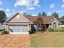 Charming single-story home with a well-manicured lawn, attached garage, and inviting front walkway at 200 Silverbelle Blvd., Longs, SC 29568