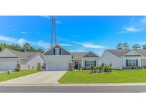 Charming single-story home features a well-manicured lawn and a welcoming front entrance at 223 Lakota Loop, Longs, SC 29568