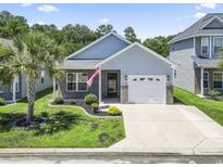 Charming single-story home with a well-manicured lawn, an attached garage, and inviting curb appeal at 236 Palm Cove Circle, Myrtle Beach, SC 29588