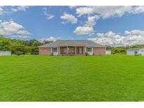 Charming brick home on a spacious lawn with a covered porch and a symmetrical design at 2829 Highway 129, Galivants Ferry, SC 29544