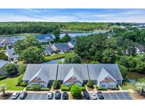 Stunning aerial view of townhomes nestled along a scenic river with lush greenery and water views at 4520 Lighthouse Dr. # 29B, Little River, SC 29566