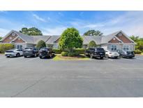 Well-maintained condos with a parking lot and a manicured green space island at 4520 Lighthouse Dr. # 29B, Little River, SC 29566