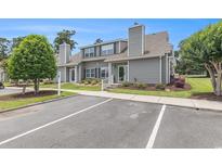 Charming condo with gray siding, manicured lawn, and convenient parking space at 503 N 20Th Ave. N # 41D, North Myrtle Beach, SC 29582