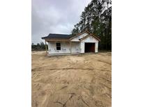 New construction exterior with Tyvek wrap, black roof and attached garage, ready for customization at 5713 S Highway 41, Marion, SC 29571