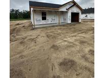 New home exterior, with dark roof and visible Tyvek wrap awaiting finishing touches at 5721 S Highway 41, Marion, SC 29571