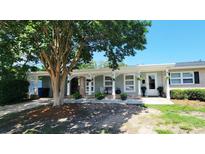 Charming single-story home with a brick facade, covered porch, mature tree, and beautifully landscaped front yard at 610 Hibiscus Ave. # 610, Myrtle Beach, SC 29572