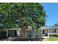 Charming single-story home featuring a welcoming front porch with decorative lattice and a well-maintained yard at 610 Hibiscus Ave. # 610, Myrtle Beach, SC 29572