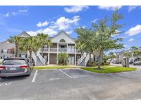 Inviting condominium exterior featuring a two-story design with charming balconies and well-maintained landscaping at 876 Palmetto Trail # 103, Myrtle Beach, SC 29577