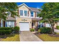 Charming two-story home featuring a balcony, attached garage and manicured lawn in a friendly neighborhood at 100 Culpepper Way # 1003, Myrtle Beach, SC 29579
