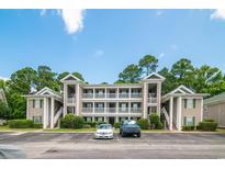 Low angle view of a condominium with beautiful trees and landscaping at 1125 Blue Stem Dr. # 29F, Pawleys Island, SC 29585