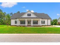 Charming single-Gathering home with a covered front porch, manicured lawn, and traditional architectural style at 116 Sago Palm Dr., Myrtle Beach, SC 29579
