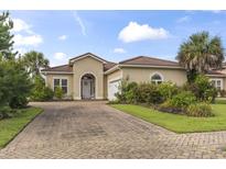 Charming single-story home with a brick driveway and lush landscaping at 165 Northside Dr., Little River, SC 29566