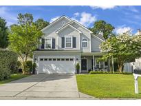 Charming two-story home with a well-manicured lawn, two-car garage, and inviting front porch at 185 Rocko Dr., Myrtle Beach, SC 29579