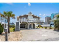 Inviting exterior of home featuring a charming front deck, convenient parking, and beachside vibe at 204 55Th Ave. N, North Myrtle Beach, SC 29582