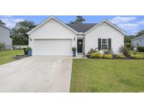 Charming single-story home featuring a white exterior, manicured lawn, and a two-car garage at 247 Grove Park Grove Park Loop, Murrells Inlet, SC 29576
