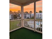 Enjoy sunset views of the community pool from this cozy condo balcony at 2498 Coastline Ct. # 301, Murrells Inlet, SC 29576