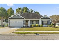 Charming single-story home with a two-car garage and well-maintained landscaping at 2715 Wood Creek Ln., Conway, SC 29527