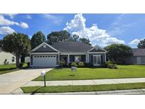 Charming single-story home featuring a well-manicured lawn, attached garage, and welcoming front porch at 2715 Wood Creek Ln., Conway, SC 29527