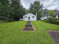 Charming one-story home with a walkway leading to the front door and green shutters at 331 Dixon St., Mullins, SC 29574
