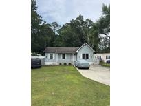 Charming single-story home featuring a well-maintained lawn and a classic covered porch at 3534 Gordon Dr., Myrtle Beach, SC 29579