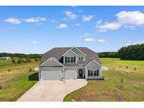 Charming two-story home boasts a three-car garage and a beautifully landscaped yard at 3617 Pasture Rd., Aynor, SC 29511