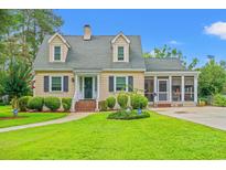 Charming home with a lush, green lawn, manicured shrubs, and inviting landscaping, plus a driveway and screened porch at 401 Harmon Park Blvd., Marion, SC 29571