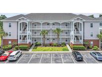 Charming condo exterior with white railings, palm trees and well maintained landscaping in a neatly kept community at 4142 Hibiscus Dr. # 102, Little River, SC 29566