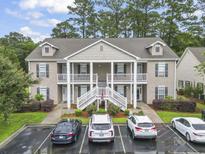 Inviting two-story condo with covered porches, manicured landscaping and convenient parking at 448 Mahogany Dr. # 201, Murrells Inlet, SC 29576